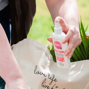 hand holding a bottle of Stay Away Mosquitoes Spray