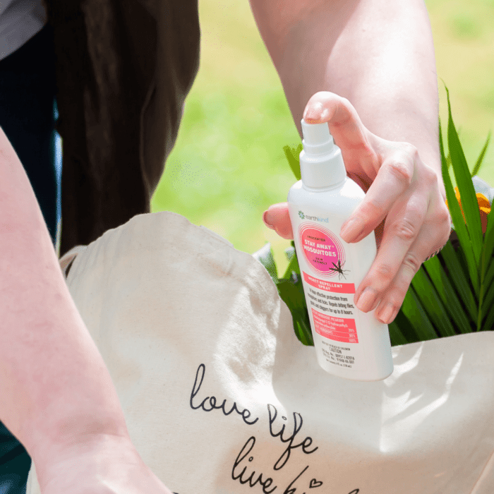 hand holding a bottle of Stay Away Mosquitoes Spray