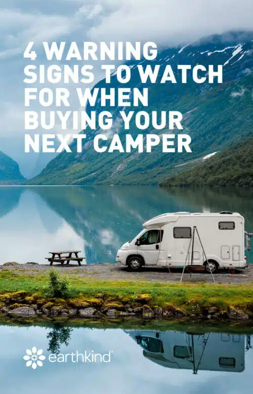 Camper van parked next to a mountain lake with the words “4 warning signs to watch for when buying your next camper” over the image.
