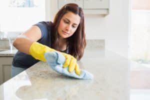 woman cleaning house to prevent pests