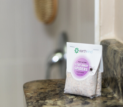 A pouch of Stay Away Spiders plant based deterrent on a bathroom ledge.