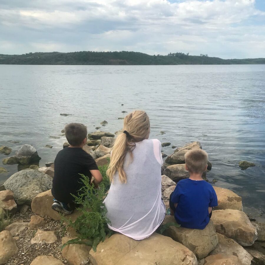 Grandmother and children looking over water