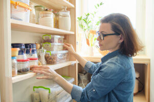 woman looking at stored food on shelf