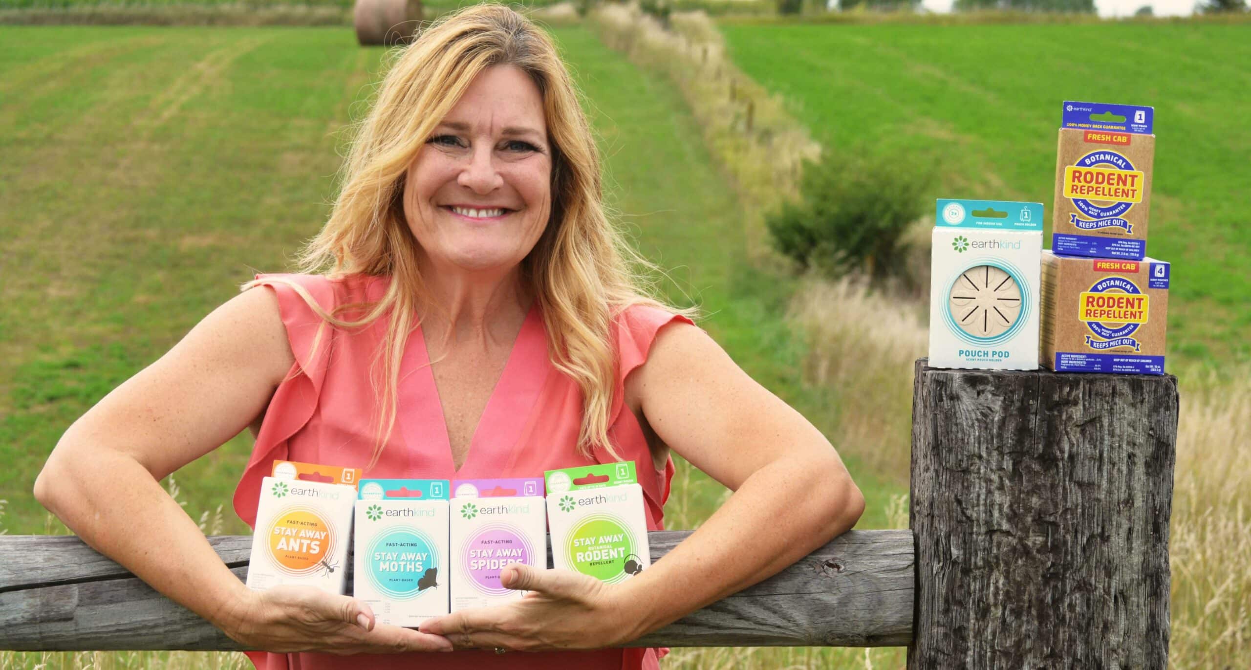 EarthKind CEO Kari Warberg Block holding Stay Away products 