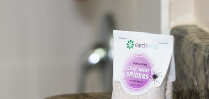 A pouch of Stay Away Spiders plant based deterrent on a bathroom ledge.