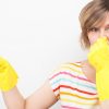 Woman plugging her nose to stop the smell of stink bugs