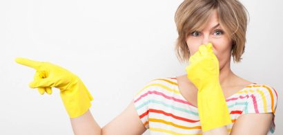Woman plugging her nose to stop the smell of stink bugs